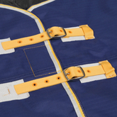 Close-up of a blue rug with yellow straps and buckles.